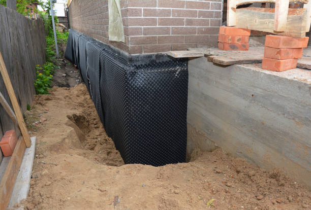 SJ Waterproofing Pros technician performing targeted Exterior Waterproofing assessment in River Rouge, MI